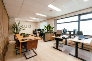 Foto van kantoor bij klein bedrijf met vier werkplekken en een eettafel.